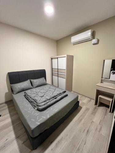 a bedroom with a bed in a room with a piano at JEC Suites in Kuching