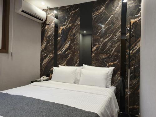 a bedroom with a large bed with a marble wall at IM Hotel in Seoul