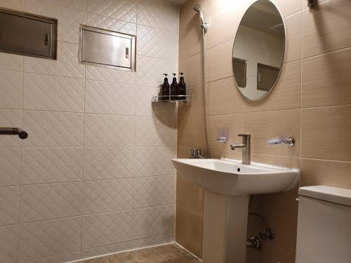 a bathroom with a sink and a mirror at IM Hotel in Seoul