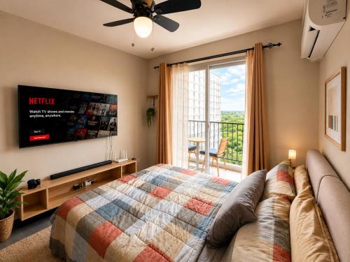 a bedroom with a bed and a tv and a balcony at Arastar Escape - Relax and Unwind- NetFlix - Fast Wifi - Pool Access in Suba