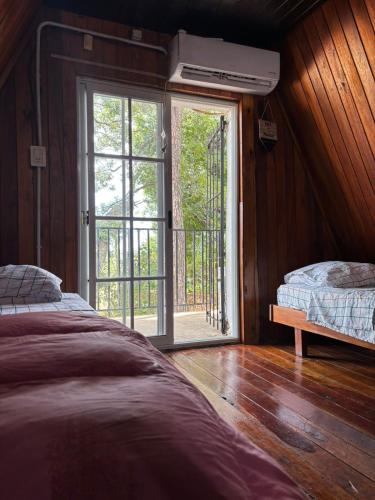 a bedroom with a bed and an open door at La Alpina playa Nebel in Concordia
