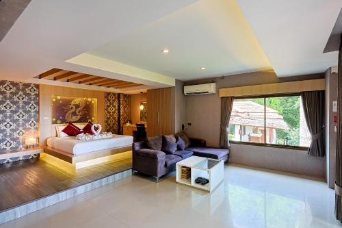 a living room with a bed and a couch at Sita Beach Resort in Ko Lipe