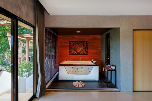 a bathroom with a large bath tub in a room at Sita Beach Resort in Ko Lipe