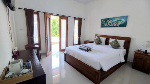 a bedroom with a bed and a television in it at Miko Bungalow Nusa Penida in Nusa Penida