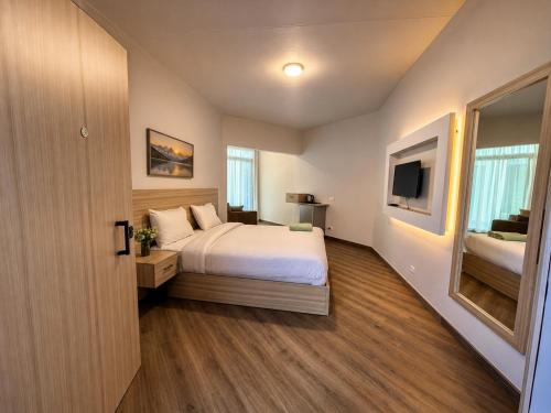 a bedroom with a bed and a flat screen tv at Hurghada Porto View in Hurghada