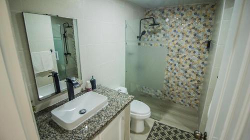 a bathroom with a sink and a toilet and a shower at Nice View always available in Juan Dolio