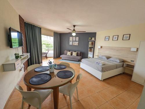 a living room with a bed and a table and chairs at Nice View always available in Juan Dolio