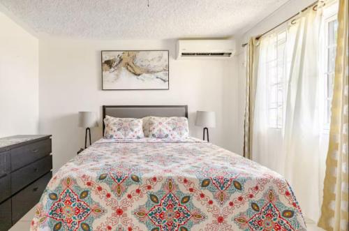 a bedroom with a large bed and a window at Oceanview Retreat - 3 bedroom in Bull Bay