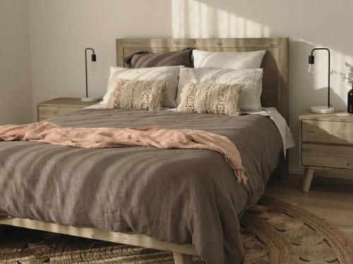 a bedroom with a large bed with pillows at Adagio at Lonsdale in Point Lonsdale