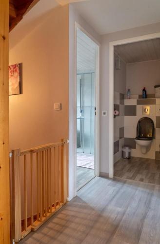 a hallway with a door leading to a bathroom at Gîte de montchamp in Arzenc-dʼApcher