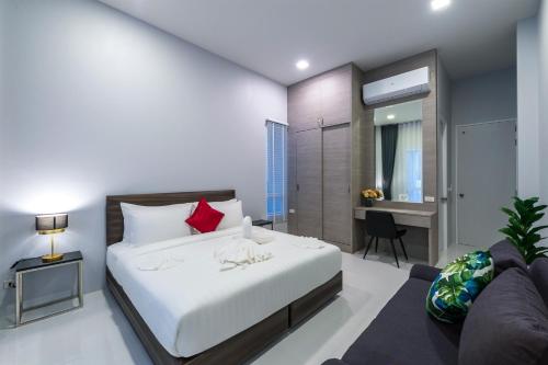 a bedroom with a bed and a living room at The Garnet Light Pool Villa Aonang-3BR Private Pool Villa in Ao Nang Beach