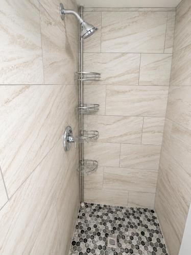 a shower with a shower head in a bathroom at Sin City Hostel in Las Vegas