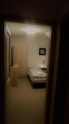 a bedroom with a bed and a table and a mirror at Hostinské pokoje U Kulináře in Domažlice