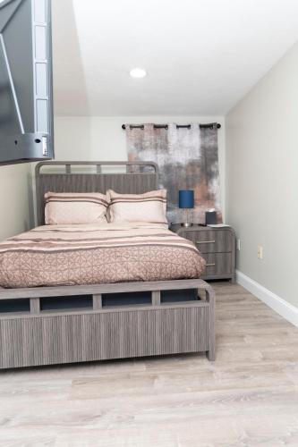 a bedroom with a large bed and a table at Juliet's Cozy Retreat in Worcester