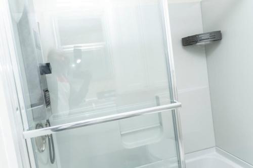 a shower with a glass door in a bathroom at Juliet's Cozy Retreat in Worcester