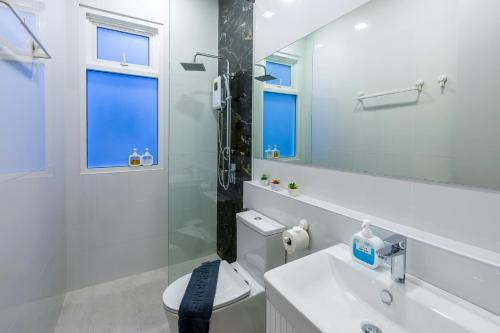 a bathroom with a toilet and a sink and a mirror at The Garnet Light Pool Villa Aonang-3BR Private Pool Villa in Ao Nang Beach