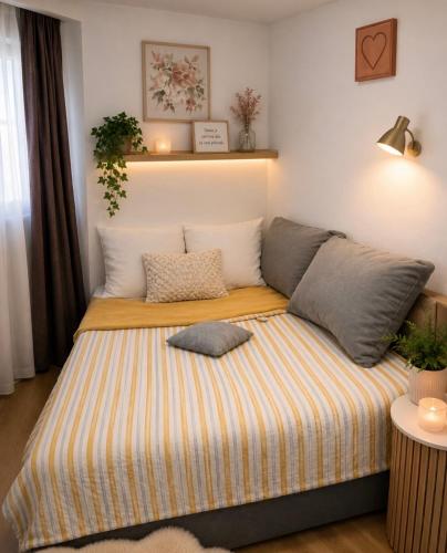 a bed with pillows on it in a room at Apartment ALMA- Vodnjan- smještaj blizina mora sa besplatnim javnim parkingom in Vodnjan