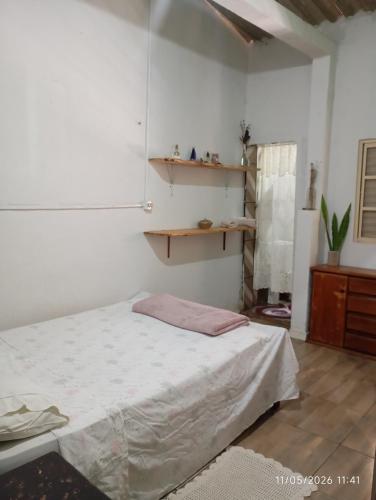 a bedroom with a bed and a wooden cabinet at Casa Baunilha in Cavalcante