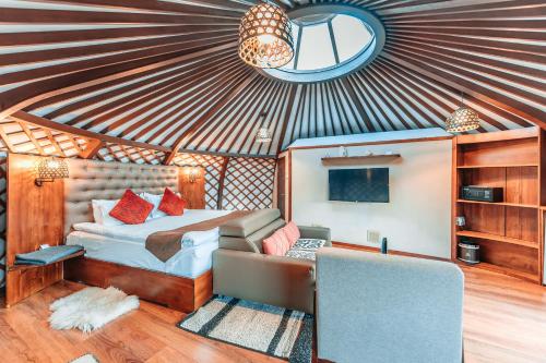 a bedroom with a bed and a tv in a room at Red Rock Resort Mongolia in Yoliin Hural