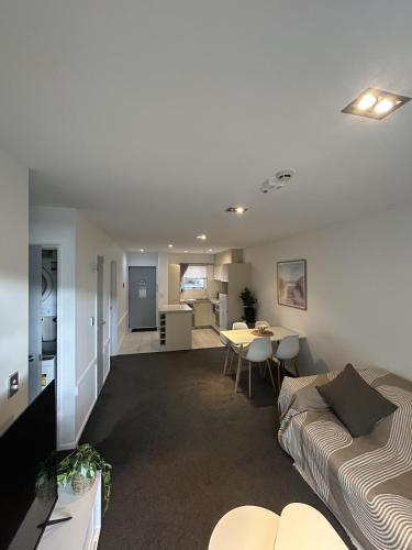 a living room with a couch and a table at Wānaka Edge Retreat in Wanaka