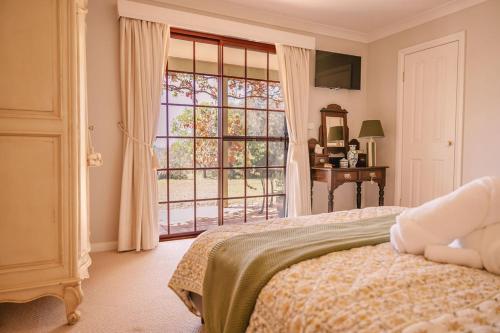a bedroom with a bed and a large window at 'Videre' in Rylstone