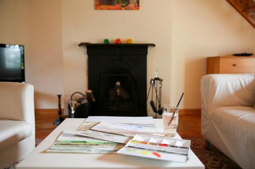 a living room with a coffee table with a fireplace at Killeena House in Baltimore