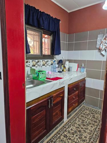 a kitchen with a sink and a counter top at Mathildah's Appartements in Libreville
