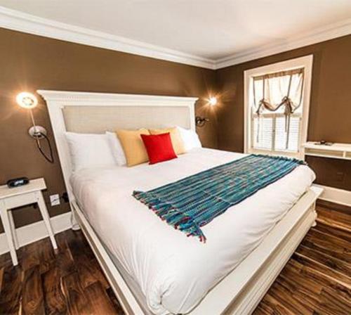 a bedroom with a large white bed with colorful pillows at Logan Inn in New Hope
