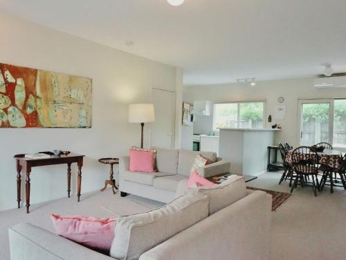 a living room with a couch and a table at Glan Mor in Queenscliff