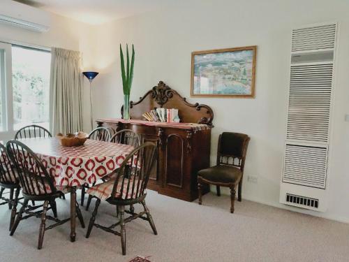 a dining room with a table and chairs at Glan Mor in Queenscliff