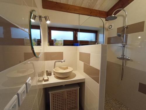 a bathroom with a sink and a shower at La maisonnette in Marvejols