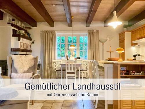 a kitchen and dining room with a table and chairs at Reetdachhaus in Seenähe, Ruhige Lage, Kamin & Terrasse in Seedorf