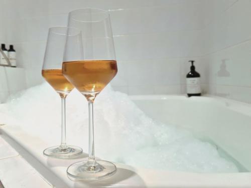 two glasses of wine sitting in a bath tub at Intermission in Queenscliff