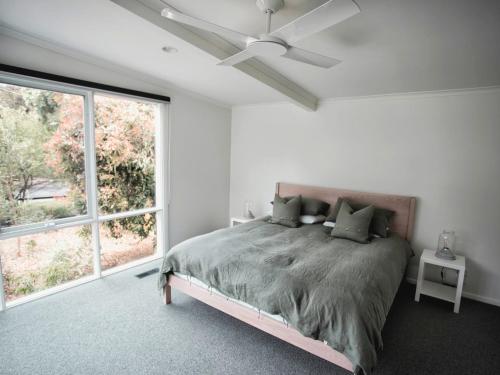 a bedroom with a bed and a ceiling fan at Lonsdale on Glaneuse in Point Lonsdale