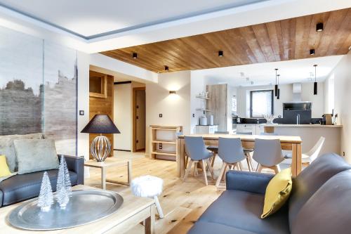 a living room with a couch and a table at Appartements Bétemps in Le Grand-Bornand