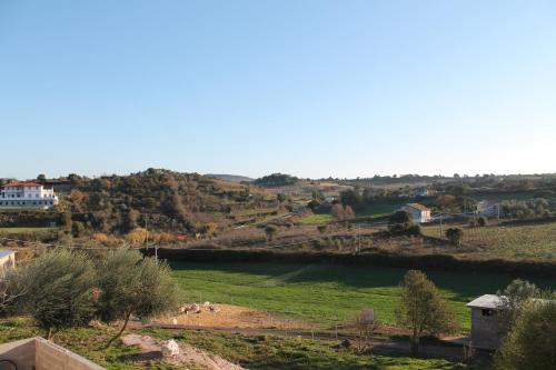 a view of a green field and a river at Agriturismo Su Recreu in Ittiri