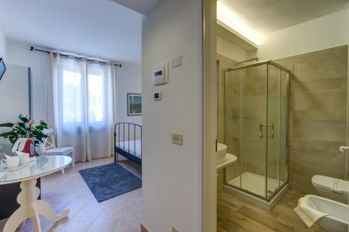 a bathroom with a glass shower and a table at Albergo Al Castello in Gavi