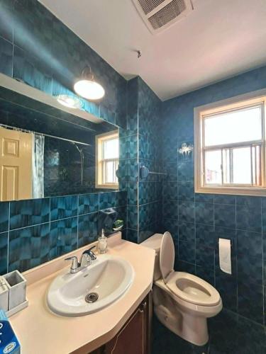 a bathroom with a sink and a toilet at TORONTO Midtown HomeHaven in Toronto