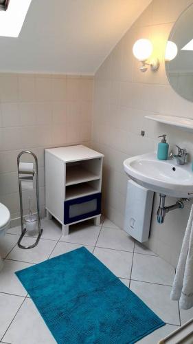 a bathroom with a sink and a toilet and a mirror at Apartment Jackie 2 in Bielefeld