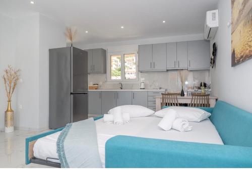 a kitchen with a large bed in a room at Rhea Central Luxury Apartment in Samos