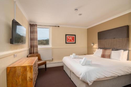 a hotel room with a large bed and a window at Honest Lawyer Hotel in Durham
