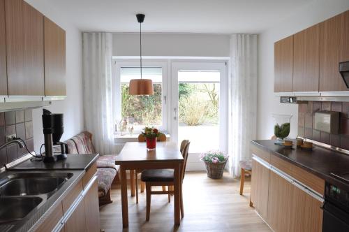 a kitchen with a table and a dining room at Göcke's Haus und Garten in Wettringen