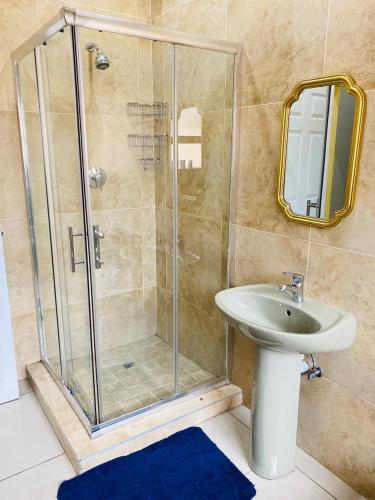 a bathroom with a shower and a sink at Smileys accomodation in Standerton