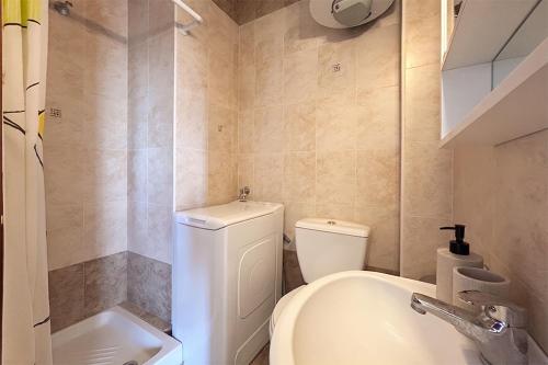 a small bathroom with a toilet and a sink at Petra Afytos holiday in Afitos