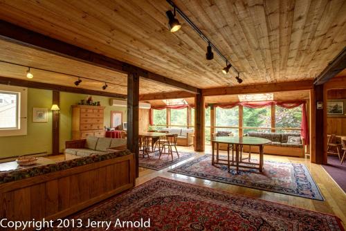 a living room with a couch and a table at Snowy Owl Inn in Waterville Valley