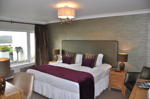 a bedroom with a large bed and a large window at Beech Hill Hotel & Spa in Windermere