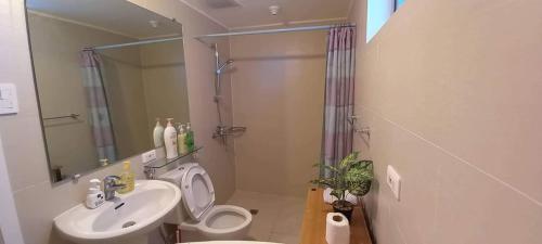 a bathroom with a toilet and a sink and a shower at Azure North MiCasa in San Fernando