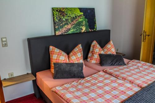 a bedroom with a bed with two pillows at Pension Andries in Ernst