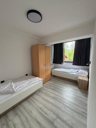 a bedroom with two beds and a window at Aqua apartment in Gornji Ribnik