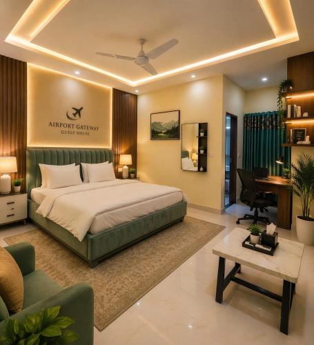 a bedroom with a king sized bed and a desk at Airport Gateway Guesthouse in Rawalpindi